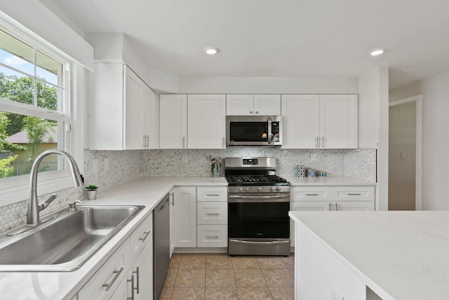 814 N Mamer Rd, Spokane Valley, WA 99216 - kitchen with appliances with stainless steel finishes, a sink, white cabinets, tasteful backsplash, and recessed lighting