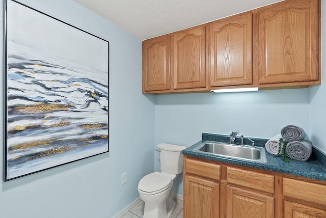 814 N Mamer Rd, Spokane Valley, WA 99216 - half bathroom with vanity, toilet, tile patterned floors, baseboards, and a textured ceiling