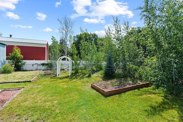 814 N Mamer Rd, Spokane Valley, WA 99216 - view of green lawn with a vegetable garden, a pole building, and an outbuilding