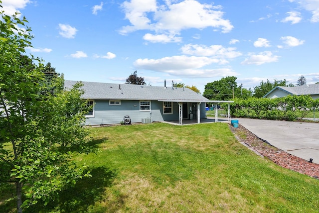 814 N Mamer Rd, Spokane Valley, WA 99216 - rear view of house with cooling unit, driveway, a lawn, and roof with shingles