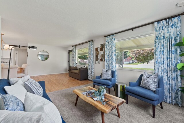 814 N Mamer Rd, Spokane Valley, WA 99216 - living area with a textured ceiling, wood finished floors, a chandelier, and baseboards