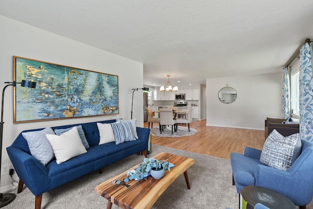 814 N Mamer Rd, Spokane Valley, WA 99216 - living area with a chandelier, light wood-type flooring, and baseboards