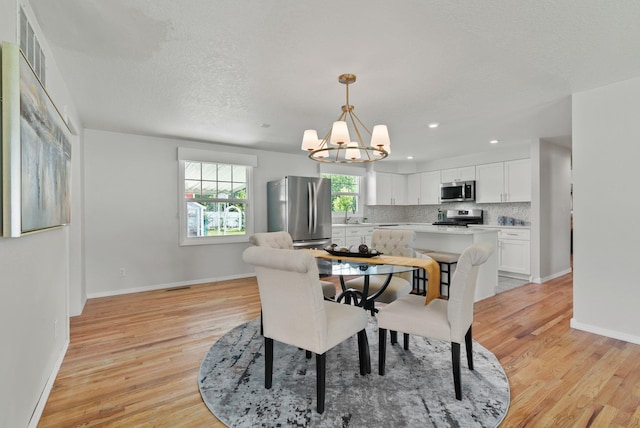 814 N Mamer Rd, Spokane Valley, WA 99216 - dining space with a chandelier, light wood-style floors, baseboards, recessed lighting, and a textured ceiling