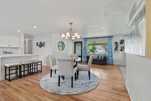 814 N Mamer Rd, Spokane Valley, WA 99216 - dining room with a chandelier, light wood-style floors, baseboards, recessed lighting, and a textured ceiling