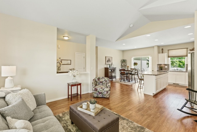 13202 N Addison St, Spokane, WA 99208 - living area featuring light wood-type flooring, vaulted ceiling, and recessed lighting