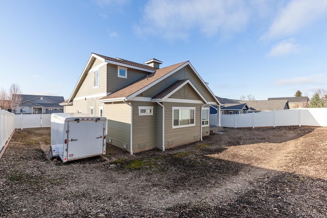 3260 W Magistrate Loop, Hayden, ID 83835 - rear view of property featuring crawl space, a fenced backyard, roof with shingles, and a storage unit