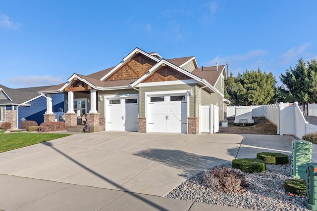 3260 W Magistrate Loop, Hayden, ID 83835 - craftsman inspired home featuring a garage, concrete driveway, and stone siding