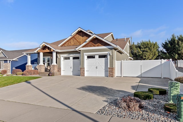 3260 W Magistrate Loop, Hayden, ID 83835 - craftsman inspired home with a gate, a garage, concrete driveway, and stone siding