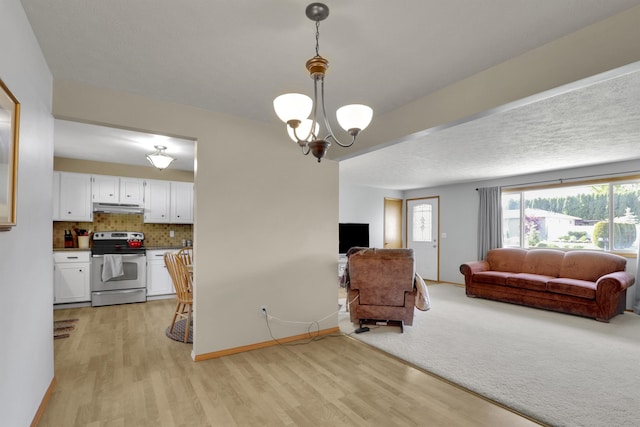 11307 E 8th Ave, Spokane Valley, WA 99206 - living room with light wood-style flooring, plenty of natural light, a chandelier, and baseboards