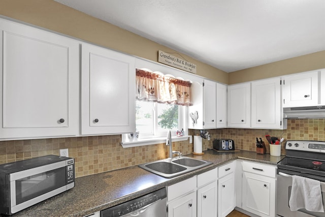 11307 E 8th Ave, Spokane Valley, WA 99206 - kitchen featuring stainless steel appliances, a sink, under cabinet range hood, white cabinetry, and dark countertops