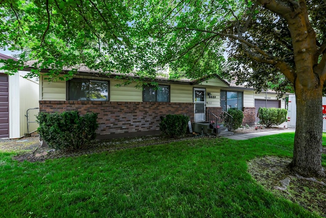 3427 S S Glenn Rd, Spokane Valley, WA 99206 - single story home with brick siding, a front yard, and a garage