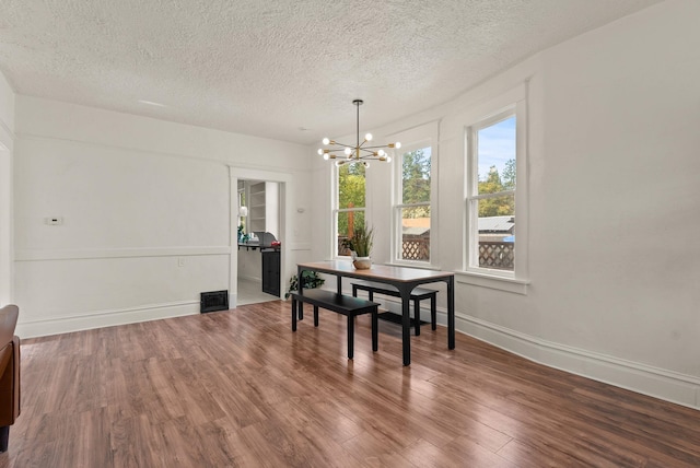 2018 E 6th Ave, Spokane, WA 99202 - dining space with a chandelier, a textured ceiling, wood finished floors, and baseboards