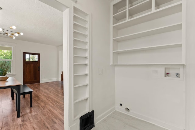 2018 E 6th Ave, Spokane, WA 99202 - laundry room featuring hookup for a washing machine, a chandelier, baseboards, wood finished floors, and a textured ceiling