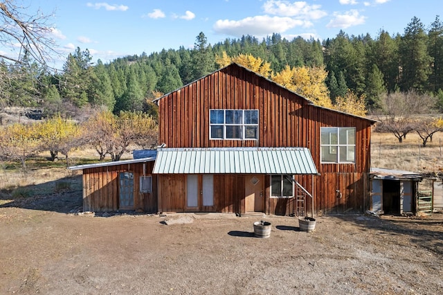 1306 Peachcrest Rd, Kettle Falls, WA 99141 - view of front of property with a wooded view, metal roof, and board and batten siding