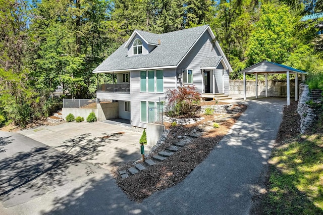 12916 N Newman St, Newman Lake, WA 99025 - view of front facade with asphalt driveway, a balcony, roof with shingles, and a detached carport