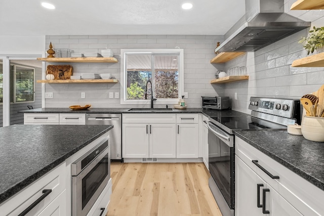 12916 N Newman St, Newman Lake, WA 99025 - kitchen featuring open shelves, stainless steel appliances, wall chimney range hood, a sink, and healthy amount of natural light
