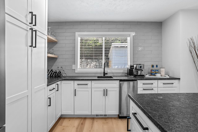 12916 N Newman St, Newman Lake, WA 99025 - kitchen with a sink, light wood finished floors, white cabinets, tasteful backsplash, and a textured ceiling