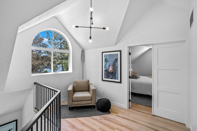 12916 N Newman St, Newman Lake, WA 99025 - bedroom with lofted ceiling, wood finished floors, a chandelier, and baseboards