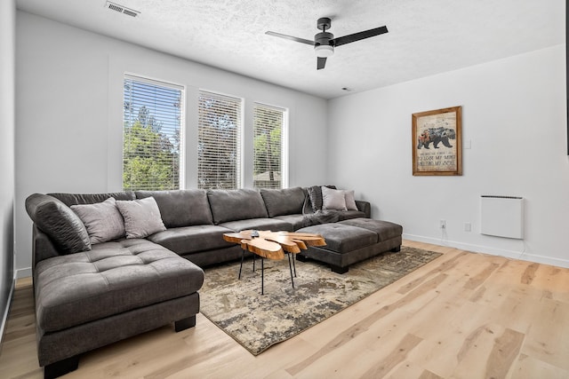 12916 N Newman St, Newman Lake, WA 99025 - living room with wood finished floors, a textured ceiling, a ceiling fan, and baseboards