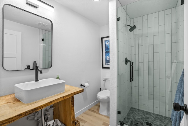 12916 N Newman St, Newman Lake, WA 99025 - full bathroom featuring a stall shower, toilet, vanity, and wood finished floors
