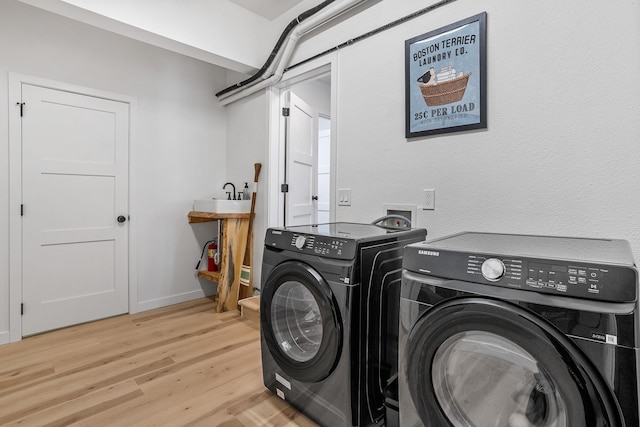 12916 N Newman St, Newman Lake, WA 99025 - laundry area featuring washing machine and clothes dryer, light wood-type flooring, and baseboards