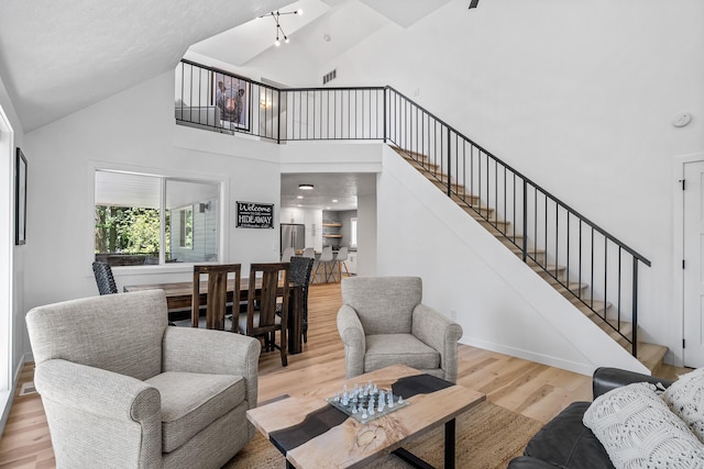 12916 N Newman St, Newman Lake, WA 99025 - living area with wood finished floors, stairs, and high vaulted ceiling