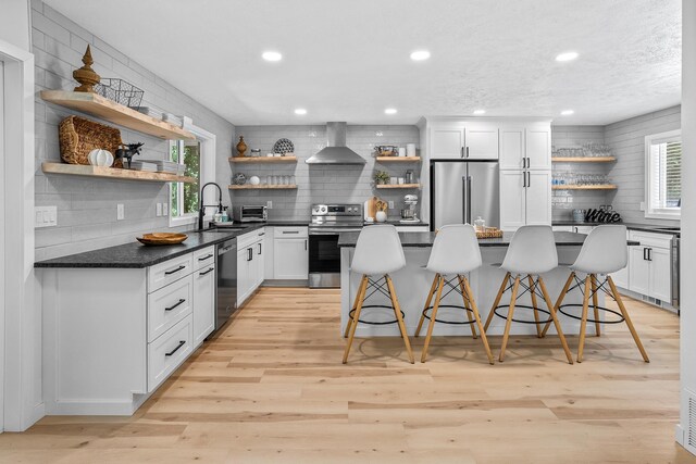 12916 N Newman St, Newman Lake, WA 99025 - kitchen with open shelves, appliances with stainless steel finishes, wall chimney exhaust hood, tasteful backsplash, and recessed lighting