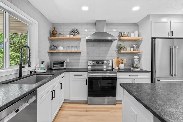 12916 N Newman St, Newman Lake, WA 99025 - kitchen featuring appliances with stainless steel finishes, wall chimney range hood, open shelves, a sink, and backsplash
