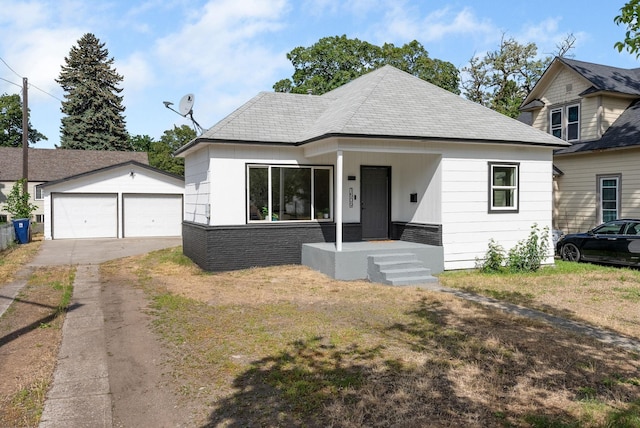 1509 N Lee St, Spokane, WA 99207 - view of front of home with an outdoor structure, a garage, and a front lawn