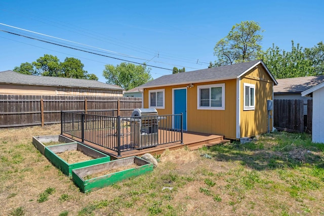 1503 E Dalton Ave, Spokane, WA 99207 - back of house with an outdoor structure, a vegetable garden, and a deck