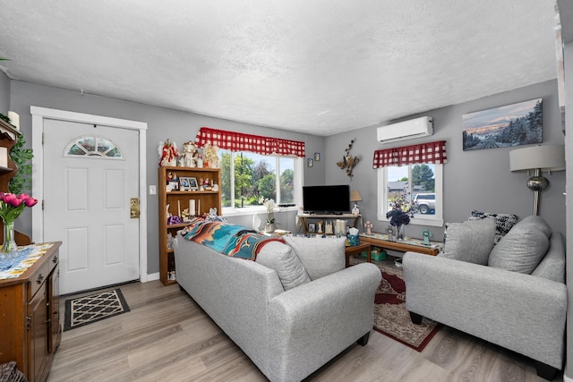 1503 E Dalton Ave, Spokane, WA 99207 - living room with an AC wall unit, light wood-type flooring, and a textured ceiling