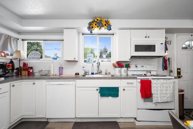 1503 E Dalton Ave, Spokane, WA 99207 - kitchen featuring white appliances, a sink, white cabinetry, and wood finished floors