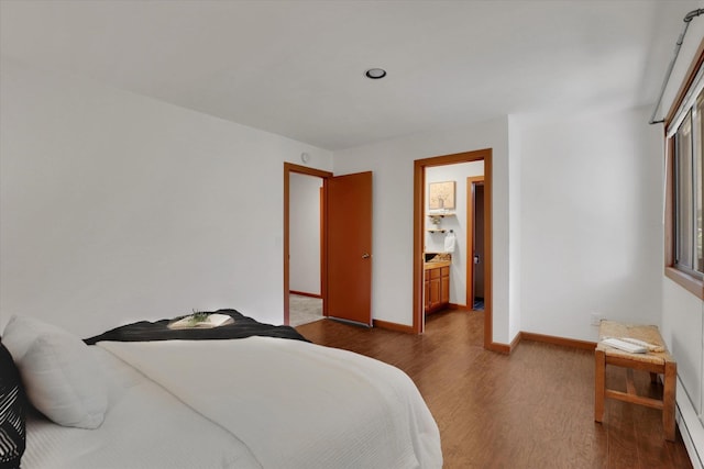 1002 W 7th Ave Unit 301, Spokane, WA 99204 - bedroom featuring dark wood-style floors, baseboards, and a baseboard heating unit