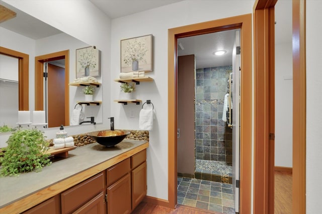 1002 W 7th Ave Unit 301, Spokane, WA 99204 - full bath featuring vanity, tiled shower, and wood finished floors