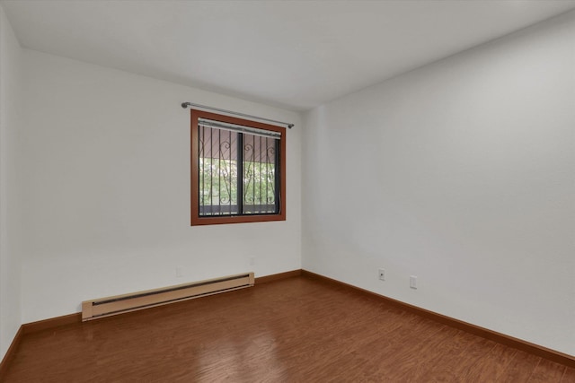 1002 W 7th Ave Unit 301, Spokane, WA 99204 - spare room with baseboard heating, dark wood-style flooring, and baseboards