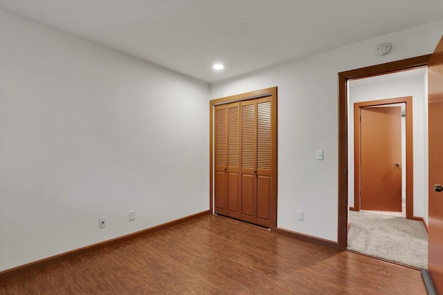 1002 W 7th Ave Unit 301, Spokane, WA 99204 - unfurnished bedroom featuring wood finished floors, a closet, baseboards, and recessed lighting