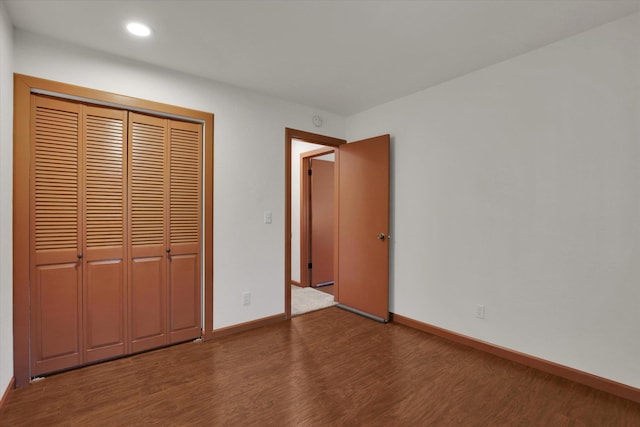 1002 W 7th Ave Unit 301, Spokane, WA 99204 - unfurnished bedroom featuring wood finished floors, baseboards, a closet, and recessed lighting