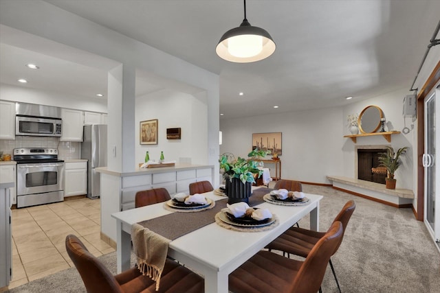 1002 W 7th Ave Unit 301, Spokane, WA 99204 - dining area featuring recessed lighting, a fireplace with raised hearth, light tile patterned floors, and baseboards