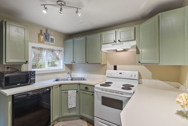 703 E Montgomery Ave, Spokane, WA 99207 - kitchen with black appliances, under cabinet range hood, green cabinetry, a sink, and light countertops