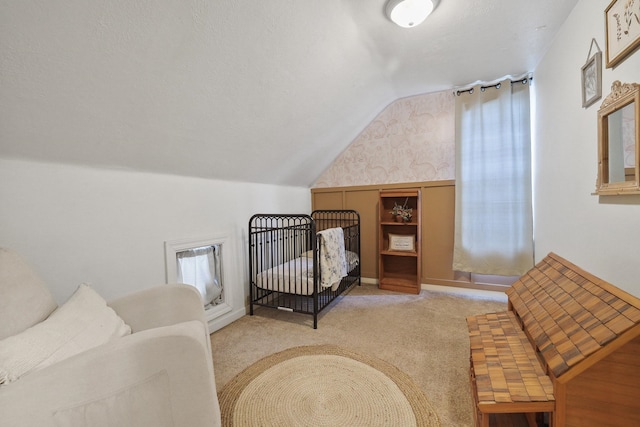 703 E Montgomery Ave, Spokane, WA 99207 - carpeted bedroom with lofted ceiling and wallpapered walls