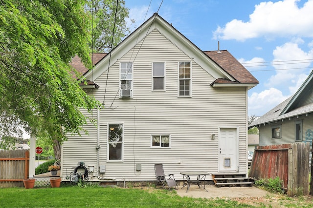 703 E Montgomery Ave, Spokane, WA 99207 - rear view of property featuring entry steps, a shingled roof, and a patio