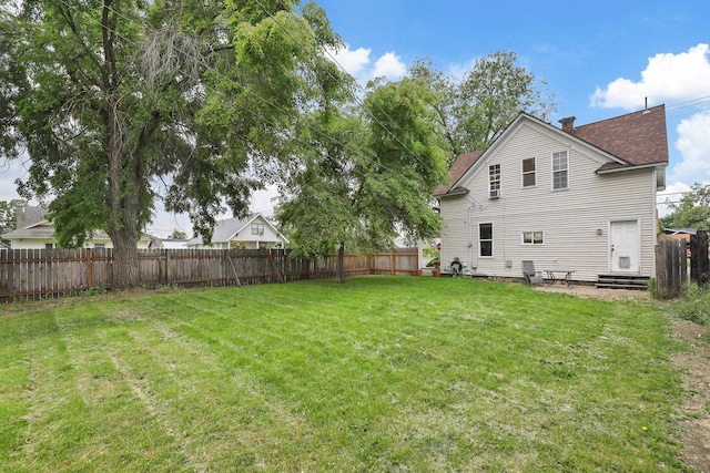 703 E Montgomery Ave, Spokane, WA 99207 - back of property featuring entry steps, a chimney, and roof with shingles
