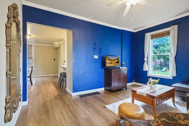 703 E Montgomery Ave, Spokane, WA 99207 - living area featuring light wood-type flooring, ornamental molding, ceiling fan, and baseboards