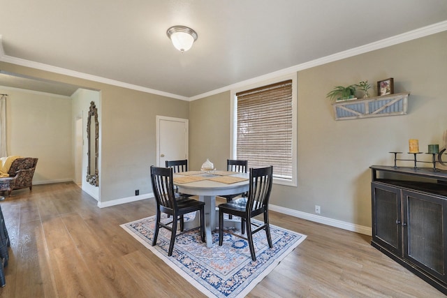 703 E Montgomery Ave, Spokane, WA 99207 - dining space with light wood-type flooring, baseboards, and ornamental molding