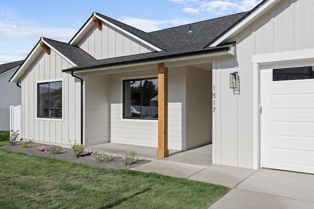 1817 N Arties Rd, Spokane Valley, WA 99016 - entrance to property featuring roof with shingles, board and batten siding, a lawn, and a garage