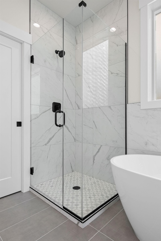 1817 N Arties Rd, Spokane Valley, WA 99016 - bathroom featuring a marble finish shower, a soaking tub, and tile patterned floors