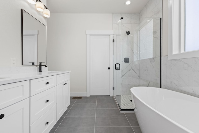 1817 N Arties Rd, Spokane Valley, WA 99016 - full bath with a soaking tub, double vanity, a stall shower, tile patterned floors, and baseboards