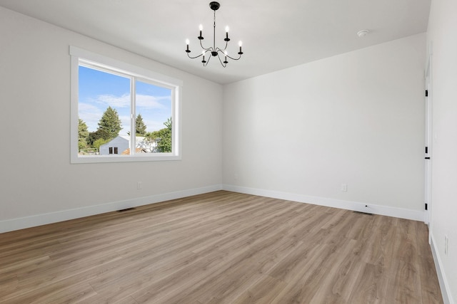 1817 N Arties Rd, Spokane Valley, WA 99016 - spare room featuring a chandelier, light wood-style floors, baseboards, and a smoke detector