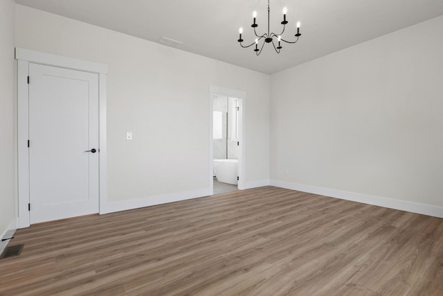 1817 N Arties Rd, Spokane Valley, WA 99016 - empty room with a chandelier, light wood-type flooring, and baseboards