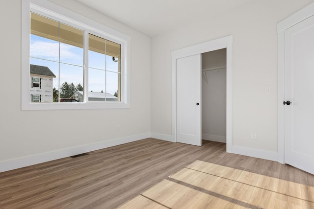 1817 N Arties Rd, Spokane Valley, WA 99016 - unfurnished bedroom with wood finished floors, baseboards, and a closet
